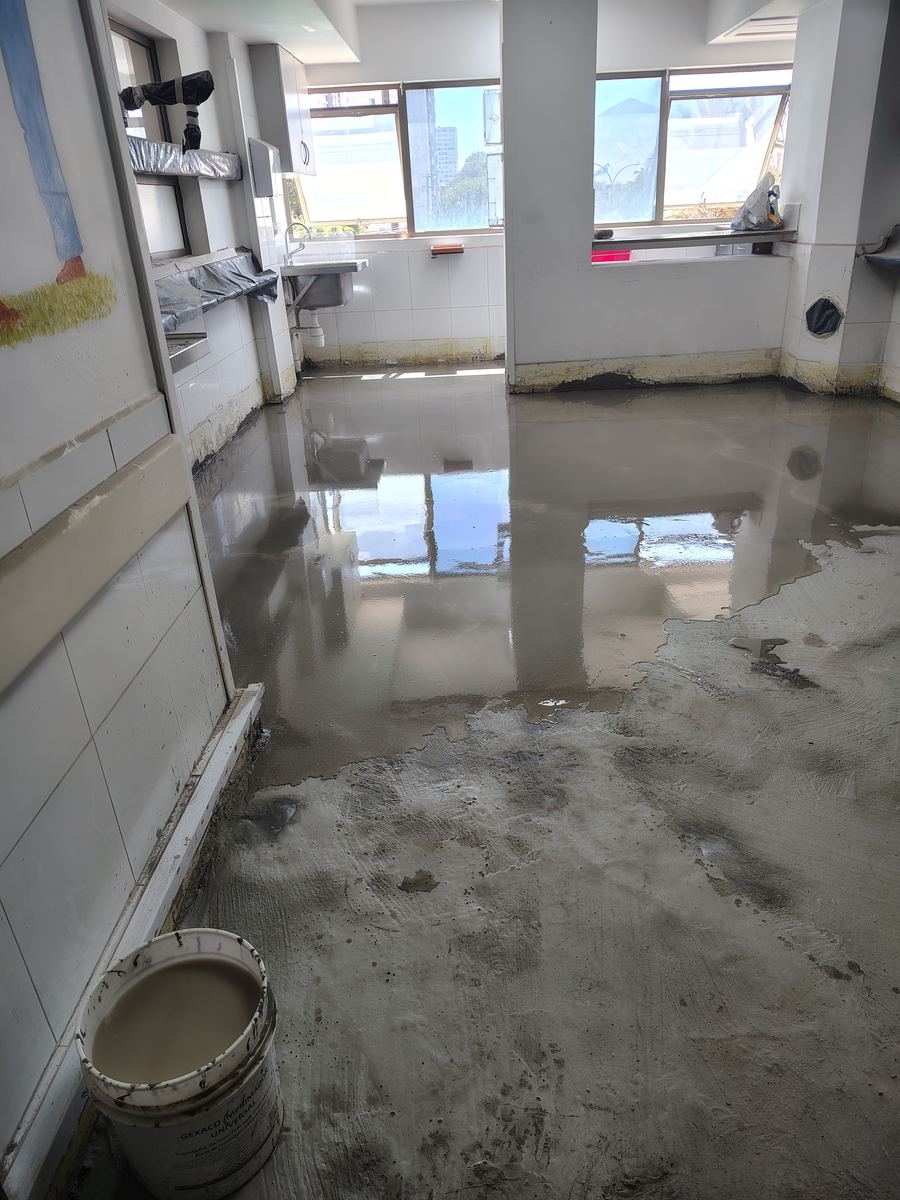 Aplicación de imprimante y mortero sobre el piso, con brillo de material fresco